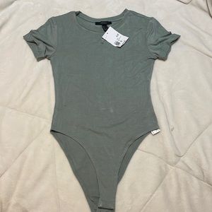 a teal body suit